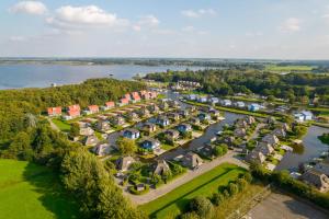 an aerial view of a row of houses next to a river at Summio Waterpark De Bloemert in Zuidlaren