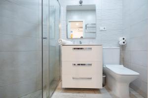 a bathroom with a toilet and a sink and a shower at ABC Apartments Madrid in Madrid