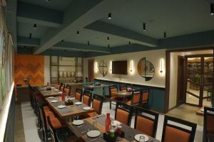 a dining room with tables and chairs in a restaurant at The Pride in Jamshedpur