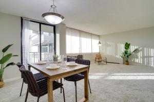 a dining room with a table and some chairs at Located Crystal City Apt with Dazzling Amenities in Arlington