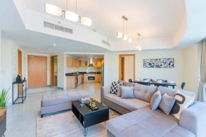 a living room with a couch and a table at LUXFolio Retreats - Spacious Luxury Unit - 3BHK in Dubai