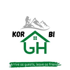 een logo voor een huis met bergen op de achtergrond bij Guest House Korabi in Ceren