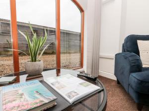 a living room with a coffee table and a window at Razorbill in Bridlington