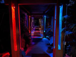 a dark hallway with red and blue lights at Vista Grande Resort - A Gay Men's Resort in Palm Springs