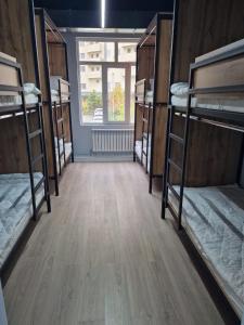 a room with several bunk beds in a building at Hostel O2 in Almaty