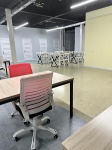 a conference room with desks and red chairs in it at Hostel O2 in Almaty