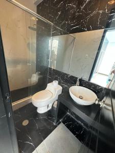 a bathroom with a toilet and a sink at la casa del encanto in Tarapoto