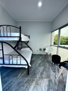 a bedroom with two bunk beds and a window at la casa del encanto in Tarapoto