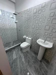 a bathroom with a toilet and a sink at la casa del encanto in Tarapoto