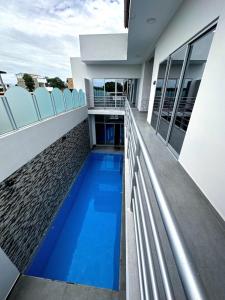 a balcony of a house with a blue swimming pool at la casa del encanto in Tarapoto