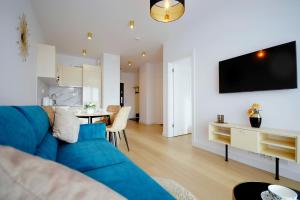 Televízia a/alebo spoločenská miestnosť v ubytovaní Apartament Lux I , Kołobrzeg Aqua Polanki , Baseny , Sauny , Siłownia