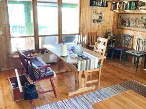 a dining room with a wooden table and chairs at Holiday home SANDÖVERKEN in Sandöverken