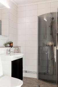 a bathroom with a sink and a shower at Skoogs Logi - Rum in Funäsdalen +47 photos