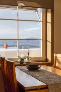 a table with a view of the ocean from a window at Skoogs Logi - Rum in Funäsdalen