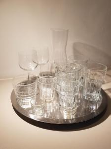 a tray filled with glasses on a table at The Superstay Boutique guestroom in Amsterdam