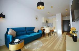 Televízia a/alebo spoločenská miestnosť v ubytovaní Apartament Lux I , Kołobrzeg Aqua Polanki , Baseny , Sauny , Siłownia