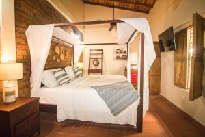 a bedroom with a white bed with a canopy at LITERATIUM in Mompos