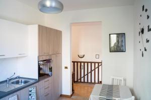a kitchen with a sink and a counter top at All’Altana b&b apartment in Marghera