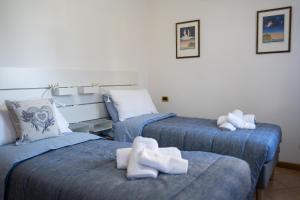 a room with two beds with towels on them at All’Altana b&b apartment in Marghera