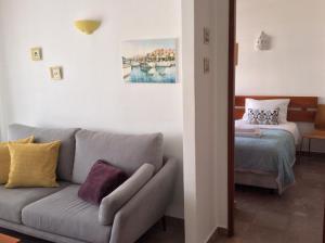 a living room with a couch and a bed at Salema Beach Apartment in Salema