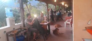 a group of people sitting at a table in a restaurant at Matilda Ec in Vilcabamba
