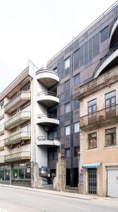 un bâtiment avec un escalier en colimaçon en face d'un bâtiment dans l'établissement Hopstays Oporto Vibes - City Center Studio, à Porto
