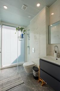 a bathroom with a toilet and a sink and a shower at Lapin Premium With Balcony By Nimizz in Tel Aviv