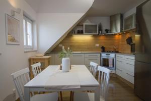 a kitchen with a table and chairs in a kitchen at Maisonette Apartment with Terrace in Koliba