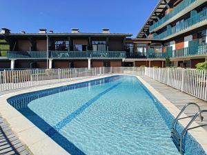 a large swimming pool in front of a building at Appartement Les Gets, 2 pièces, 4 personnes - FR-1-454-26 in Les Gets