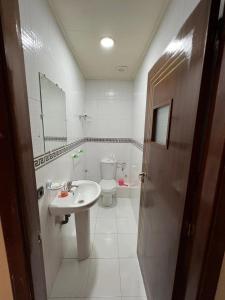 a bathroom with a sink and a toilet at Appartandalus in Larache