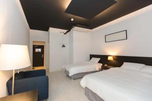 Lova arba lovos apgyvendinimo įstaigoje CANVAS BLACK Guesthouse