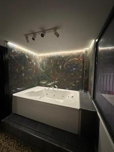 a bathroom with a bath tub in a room at Casa Rosso Suite Hotel in Istanbul