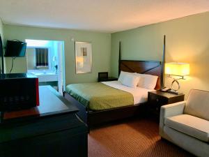 a hotel room with a bed and a couch at Executive Inn Chester in Chester +30 photos