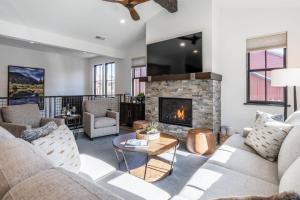 a living room with couches and a fireplace at Creekhouse 1380 in Mammoth Lakes
