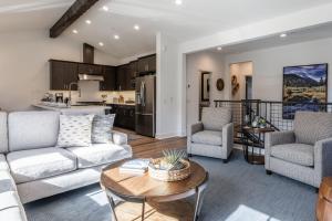 a living room with two couches and a table at Creekhouse 1380 in Mammoth Lakes