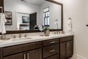 a bathroom with two sinks and a large mirror at Creekhouse 1380 in Mammoth Lakes +47 photos