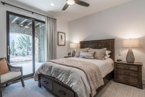 a bedroom with a bed and a chair and a window at Creekhouse 1380 in Mammoth Lakes