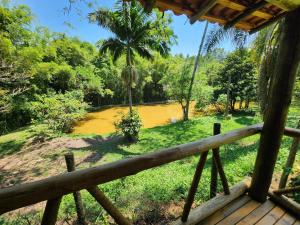 a view of a river from a porch at Sítio Belucci in Pinhalzinho