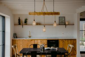 a dining room with a table and chairs at The Deerstone Luxury Eco Hideaway in Laragh