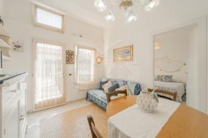 a kitchen and living room with a table and a couch at Villino Aloe - Goelba in Marina di Campo