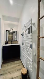 a bathroom with a sink and a mirror at Le Chalet de la Plage in Sévrier