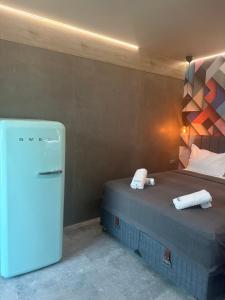 a room with a refrigerator next to a bed at Barocco Park in Skala Potamias
