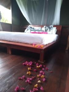 a bed with flowers on the floor in a room at Dambulla Tree House in Dambulla