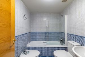 a bathroom with a tub and a toilet and a sink at El Brezo, apartamento con piscina a 3km de la playa VUT-4389-AS in Llanes +19 photos