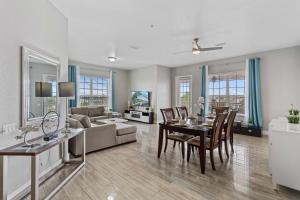 a living room with a table and a couch at 5048 Shoreway Loop 407 in Orlando