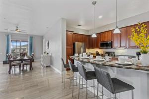 a kitchen and dining room with a table and chairs at 5048 Shoreway Loop 407 in Orlando