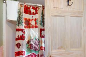 a door with a christmas patterned shower curtain at Weirs Boulevard Dreamin' in Laconia