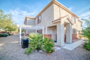 a house with a garage in front of it at Mesquite 2BR Townhome with Pool & Gym Access in Mesquite