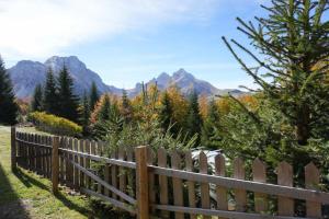 a wooden fence with mountains in the background at Weekend House Komovi-Kobildo in Kolašin