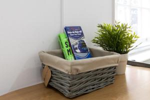 a basket filled with books and a plant on a table at London Boutique Apartments in London